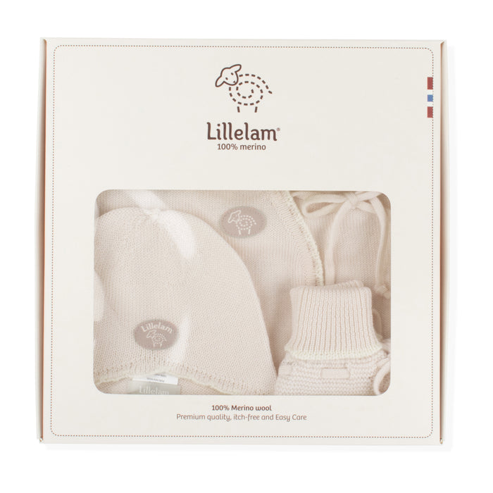 Lillelam 100% merino wool baby gift set in its original cream-colored packaging box, showing a knit hat, bootie, and swaddle blanket through a clear window.